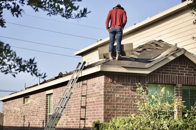 Professional roofer working on a residential roof in Lynwood